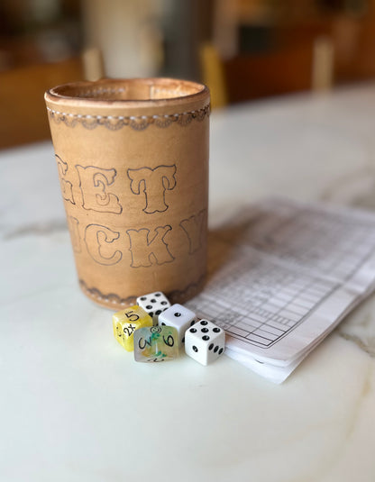handmade leather dice cup "get lucky" with a yahtzee set up